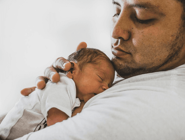 Baby sleeping on dad